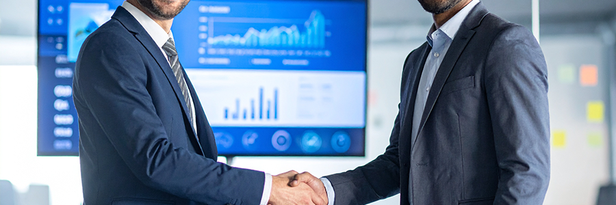 Firefly_A business executive shaking hands with a web developer in a modern office, a large s 820067