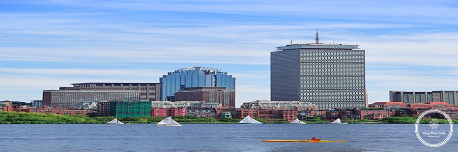 Boston city skyline with Prudential Tower and urban skyscrapers over Charles River.