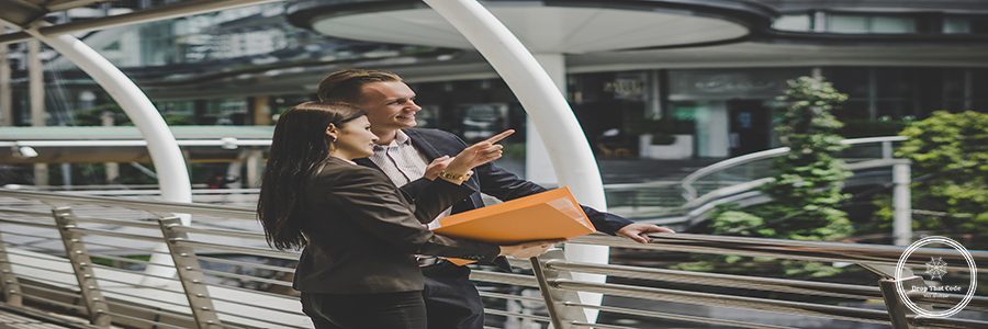 Business colleague talking and viewing documents outdoor