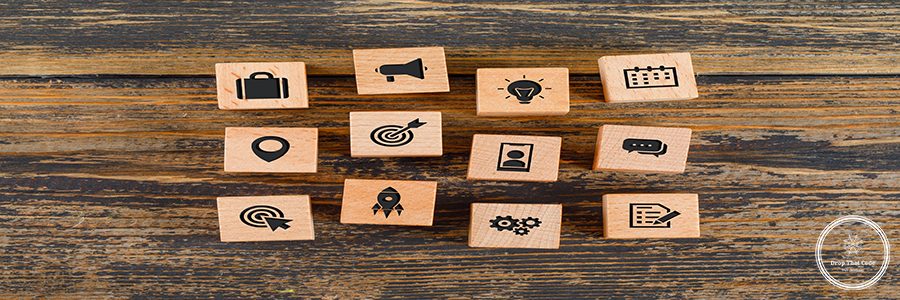 Business concept with icons on wooden cubes on wooden background flat lay.