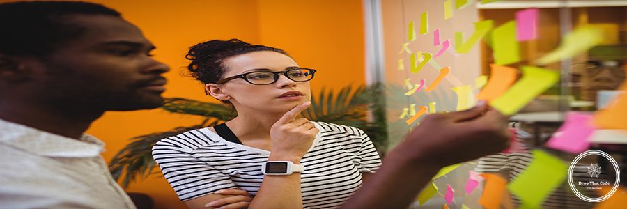 Business executives reading sticky notes in office