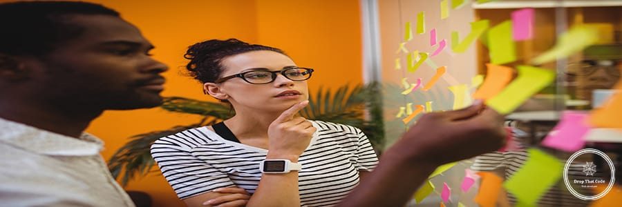 Business executives reading sticky notes in office