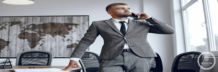 Businessman working in the office.Man is talking on the phone.Guy in a business suit