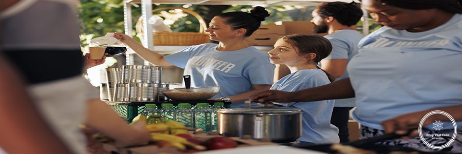 Caring volunteers bring assistance to needy at charity food drive sharing food and nourishments. Voluntary young individuals provide hunger relief to less fortunate, showcasing spirit of volunteering.
