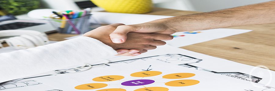 close-up-two-businessmen-shaking-hands-desk