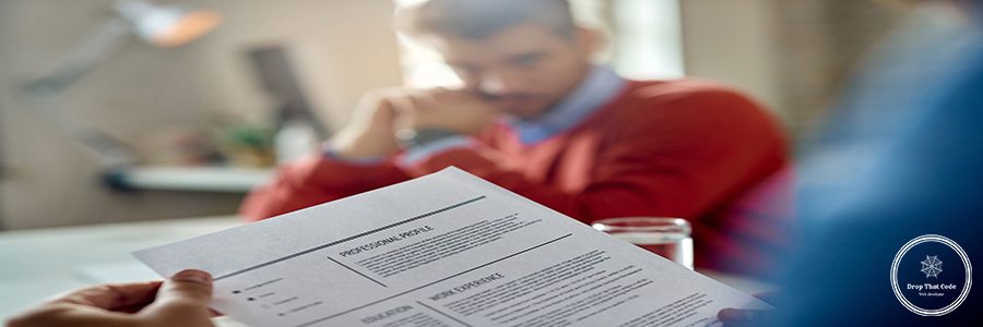 Close-up of a member of human resource teal reading candidate's CV during the meeting in the office.