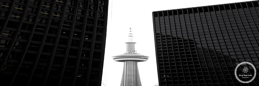 CN tower in between glass skyscrapers