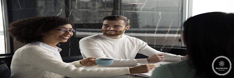 colleagues-working-together-using-documents-drinking-coffee