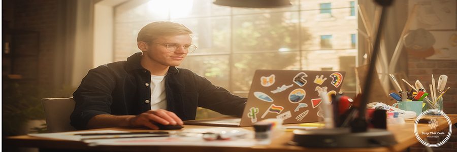 Concentrated Man Designs Video Game on His Powerful Laptop Computer in a Creative Office Space. Man Looking at Screen, Creating Digital Clothing and Footwear for Metaverse.