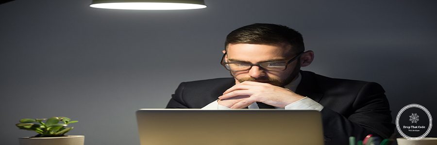 Concerned worker looking at laptop screen, thinking about problem solution, risks, company success strategies, person reading financial report. Concept of hardworking, concentration, making decision