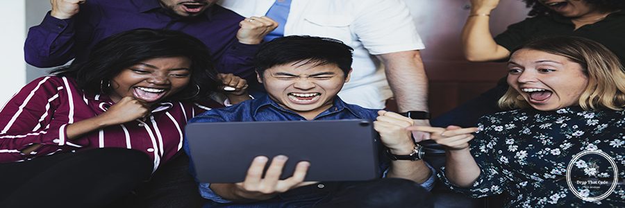 Excited business people looking at a tablet screen