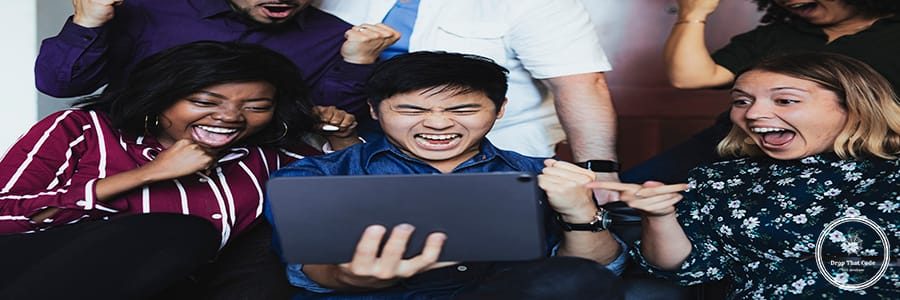 Excited business people looking at a tablet screen