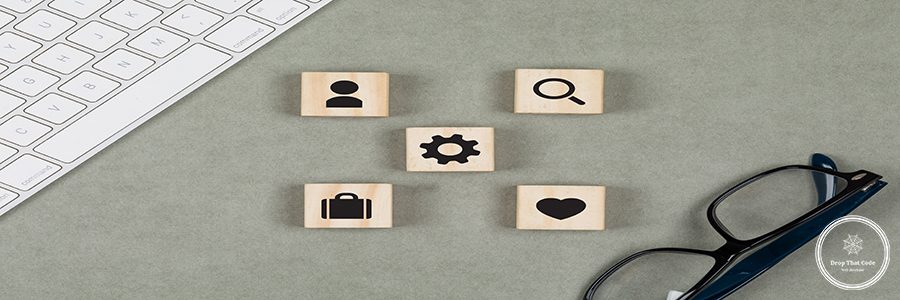 Financial concept with wooden cubes, glasses, keyboard on grey background flat lay.