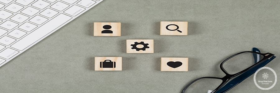 Financial concept with wooden cubes, glasses, keyboard on grey background flat lay.
