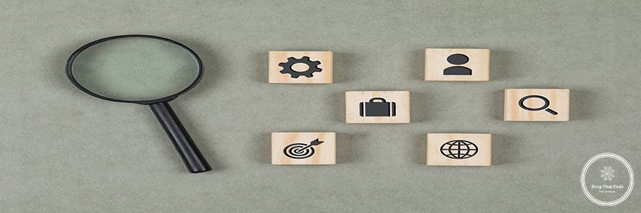 Financial concept with wooden cubes, magnifying glass on grey background flat lay.