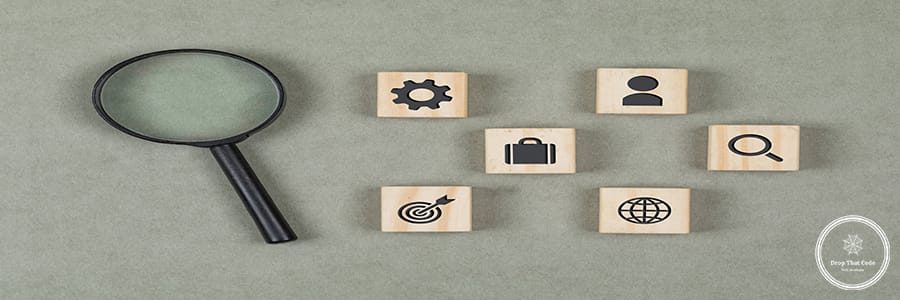 Financial concept with wooden cubes, magnifying glass on grey background flat lay.