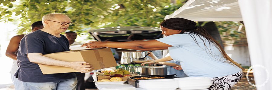 Group of volunteers distributing packaged food to those in need including homeless individuals and seniors. Their genuine act of charity brings happiness and relief to the less fortunate.