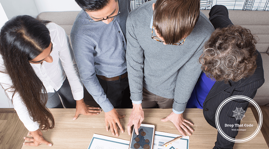 four-business-colleagues-discussing-diagrams