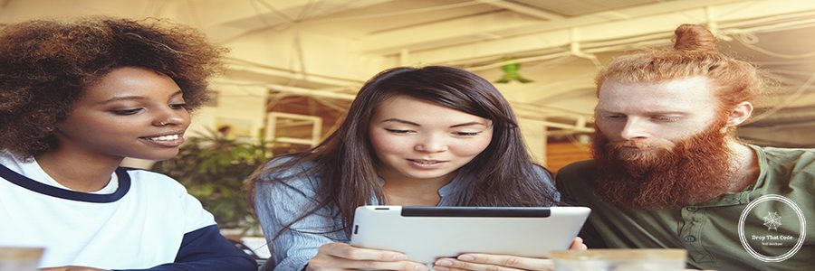 Friendship and togetherness concept. Indoor shot of Asian student girl with touch pad in her hands, sitting at coffee shop with her group mates, watching some interesting content during lunch break
