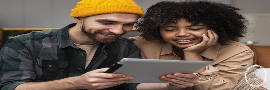 front-view-couple-looking-tablet