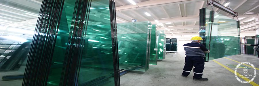 Glass manufacturing factory. Workers in the factory.