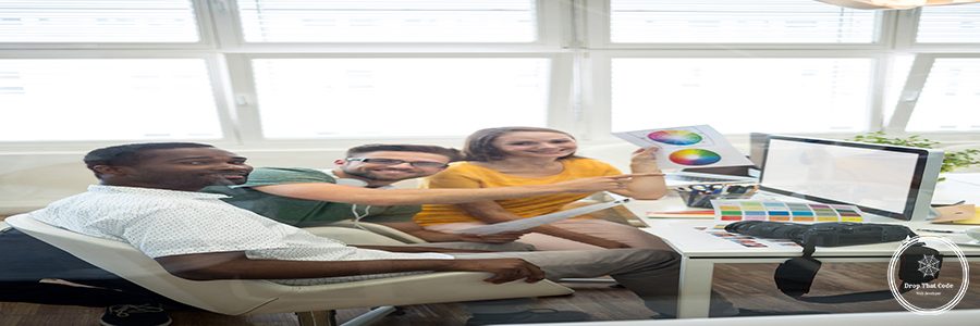 Group of graphic designers working on computer in office