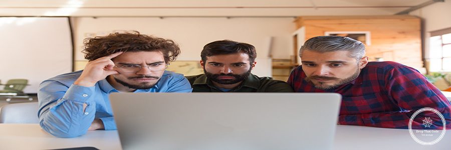 Group of male entrepreneurs in casual staring at laptop monitor. Business colleagues in casual meeting in contemporary office space. Communication concept