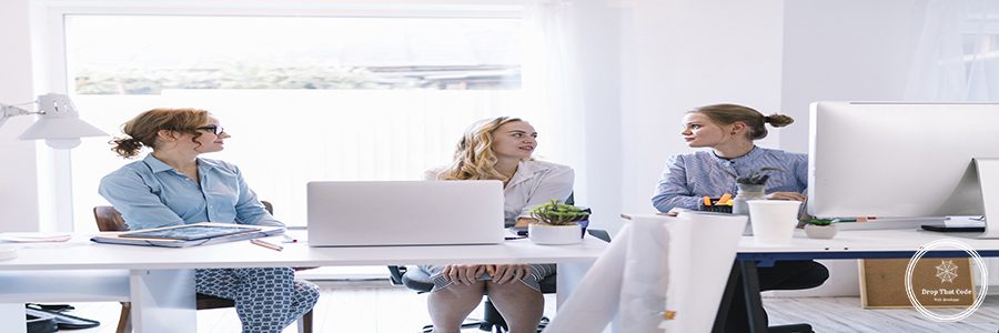 group-young-businesswomen-sitting-modern-office-talking-each-other