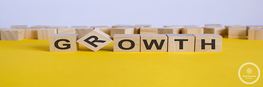 growth word written on wood block. reduction word is made of wooden building blocks lying on the yellow table. business concept