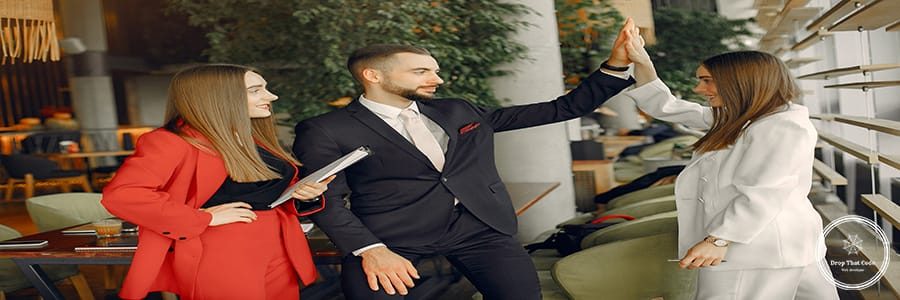 Man and two beautiful women working. People in a cafe. Twins in a elegant suits