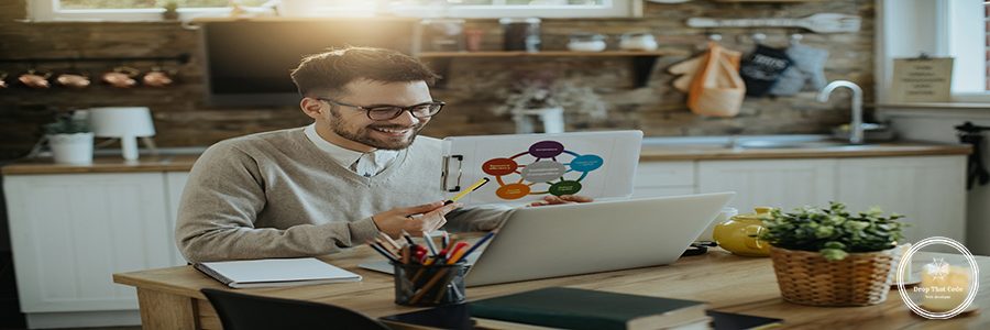Happy businessman using computer and analyzing charts during conference call at home.