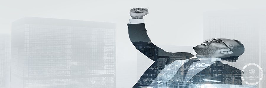 Successful businessman raising his hand in the air