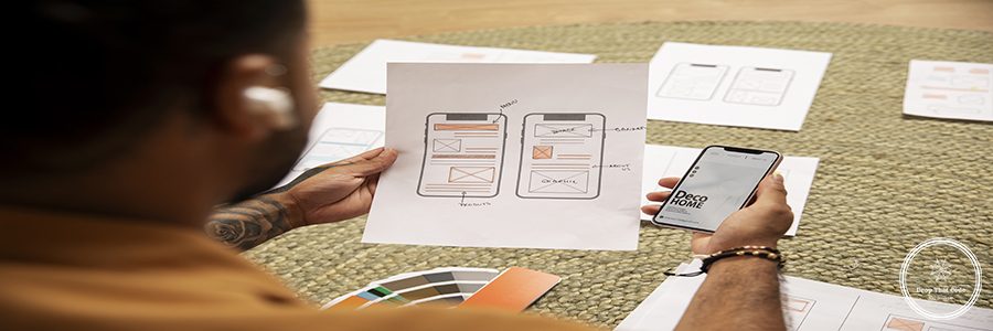 high-angle-designer-holding-smartphone