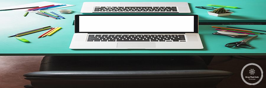 laptop-with-blank-white-screen-turquoise-table-with-nearby-chair