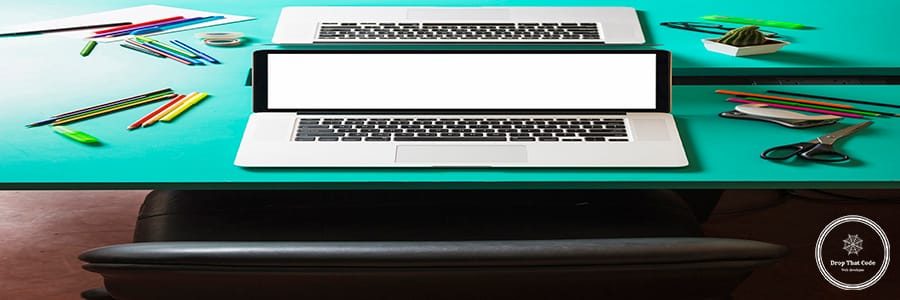 laptop-with-blank-white-screen-turquoise-table-with-nearby-chair