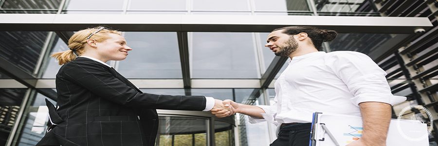 low-angle-view-businessman-businesswoman-shaking-each-other-hands