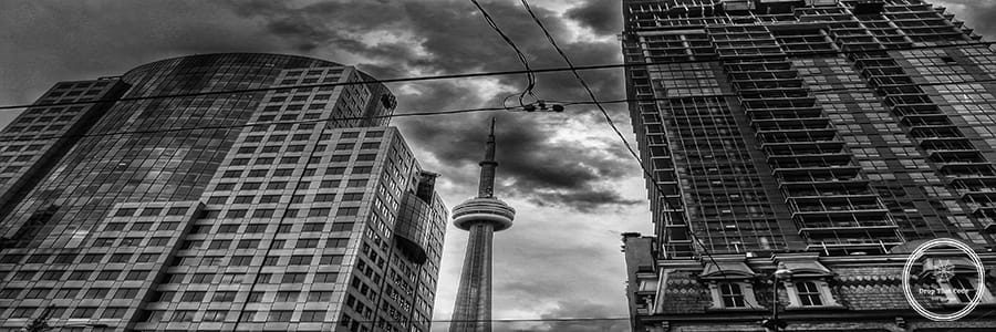 low-angle-view-modern-building-against-cloudy-sky