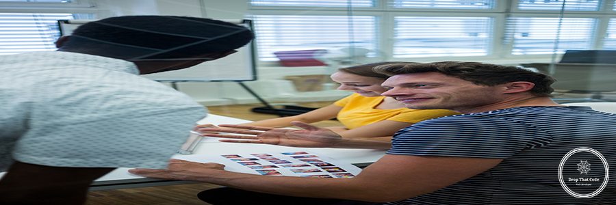 Male and female graphic designers interacting with each other in office