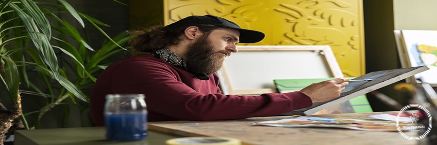 male-painter-studio-using-watercolor-his-art