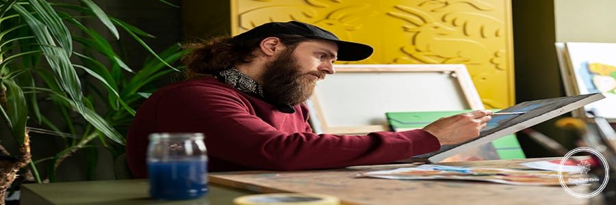 male-painter-studio-using-watercolor-his-art