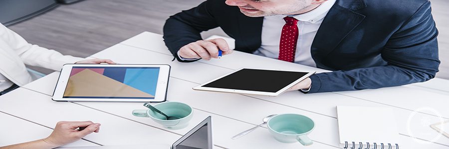 man-with-tablet-chatting-with-colleagues