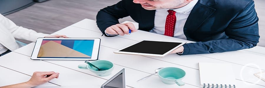 man-with-tablet-chatting-with-colleagues