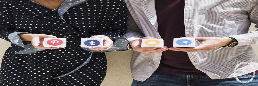 midsection-couple-holding-boxes-social-media-icons