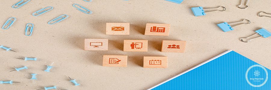 Office supplies concept with icons on wooden cubes, stationery set on paper background flat lay.