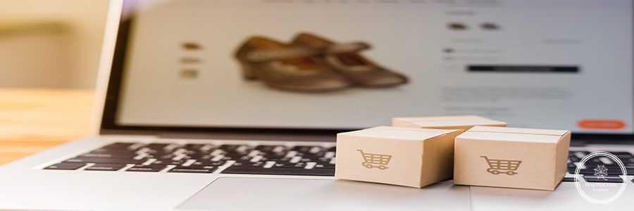 Online shopping - Paper cartons or parcel with a shopping cart logo on a laptop keyboard which web store shop on screen, Shopping service on The online web and offers home delivery.