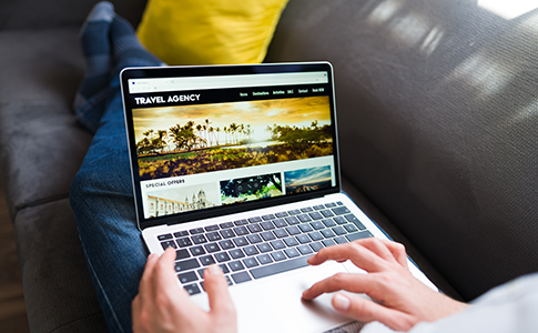 online-travel-agency-young-person-booking-vacations-holiday-laptop