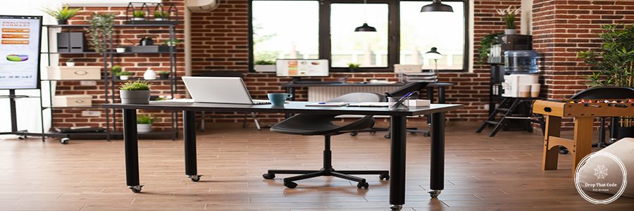 Startup office with modern furniture and company data displayed on screens of digital devices. Indoor decorations include foosball table, plants and water cooler, representing contemporary workspace.