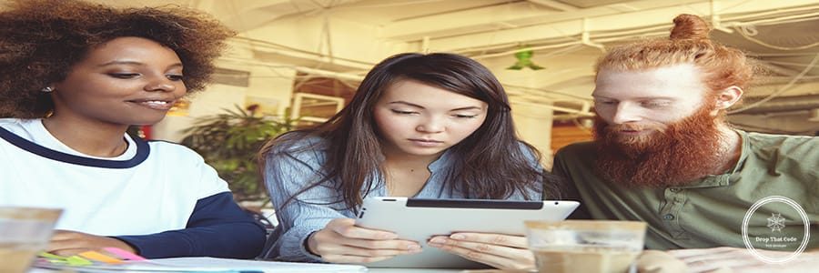 People, innovations and technology. Businesspeople studying financial data on touch pad pc with concentrated look. Attractive Asian girl holding digital tablet sitting at cafe with her partners