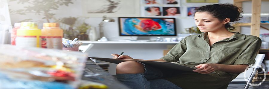 Portrait of busy confident young brunette woman designer in ripped jeans working on new art project, making drawings or sketches on tablet. Beautiful female artist absorbed with her creative work