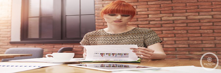 Ginger woman with stack of business documents